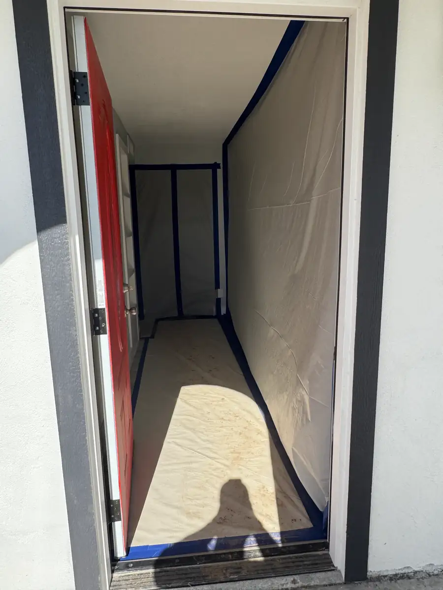 Plastic containment keeping dust out of the house during a Phoenix slab leak repair