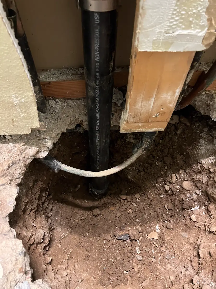 New copper water line and ABS drain set under a Phoenix slab after a leak repair